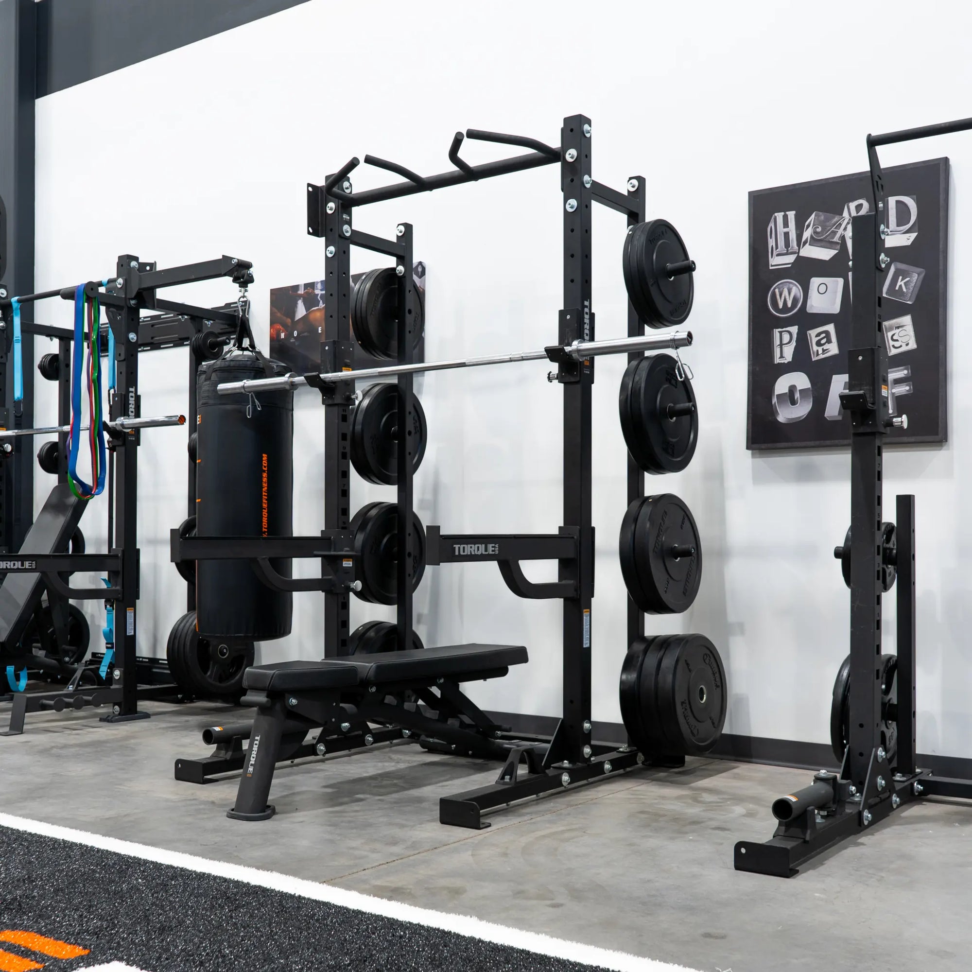 Multiple sets of Black Rubber Bumper Plates in the Torque Fitness Showroom