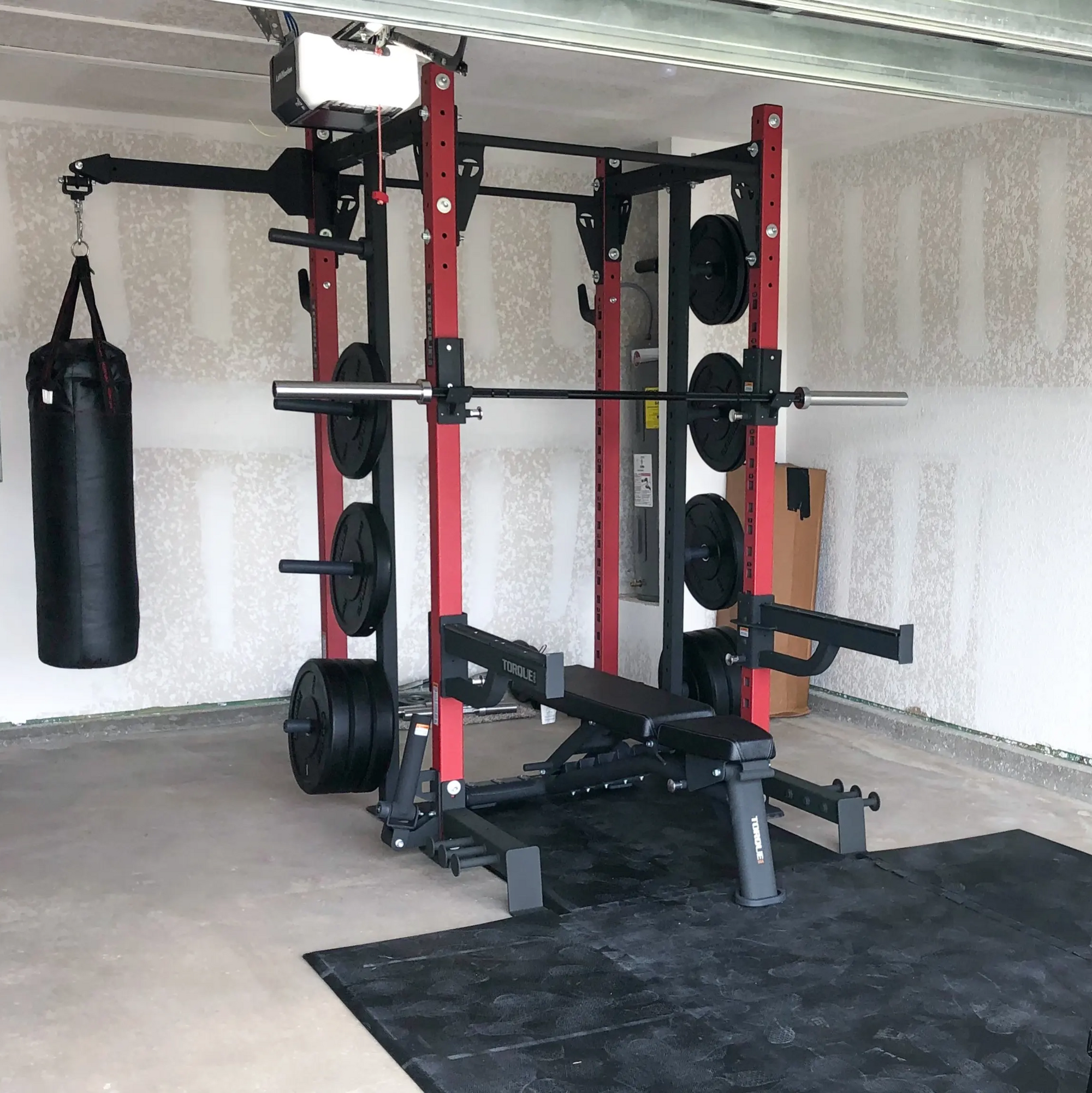 Custom Cage designed by Torque Fitness, completed with barbell & bumper plates