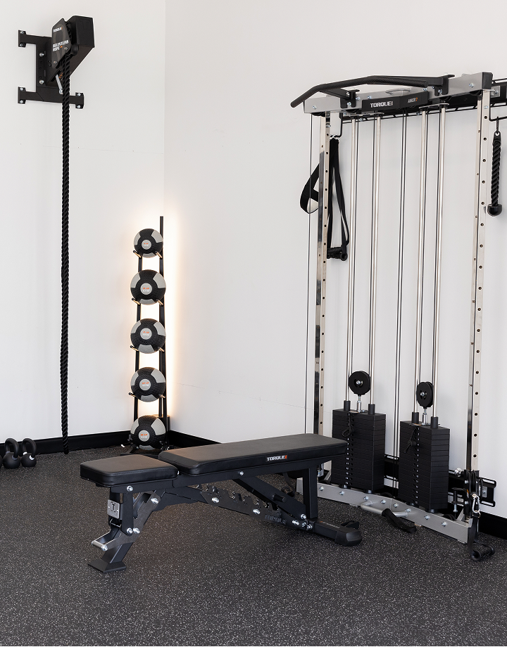 People Working Out at Home With Gym Equipment