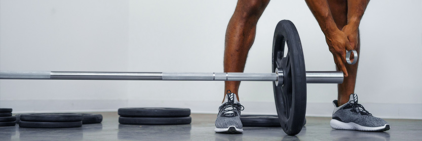 Brent Fikowski Loading Weight Plates Onto Barbell