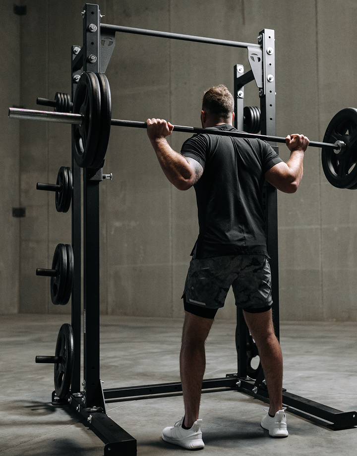 Man Powerlifting at Home With Torque Equipment Lifting Rack