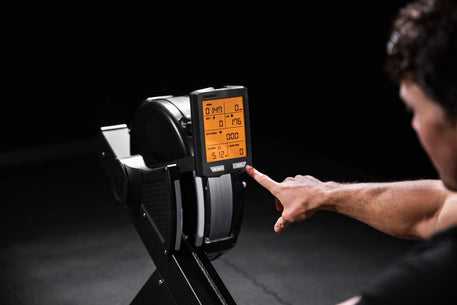 Torque Fitness Stealth Air Rower, air rower with seat rail, handle and performance console product view.