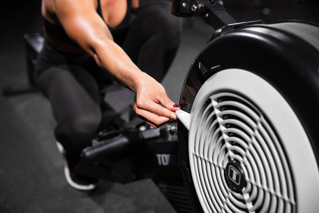 Torque Fitness Stealth Air Rower, air rower with seat rail, handle and performance console product view.