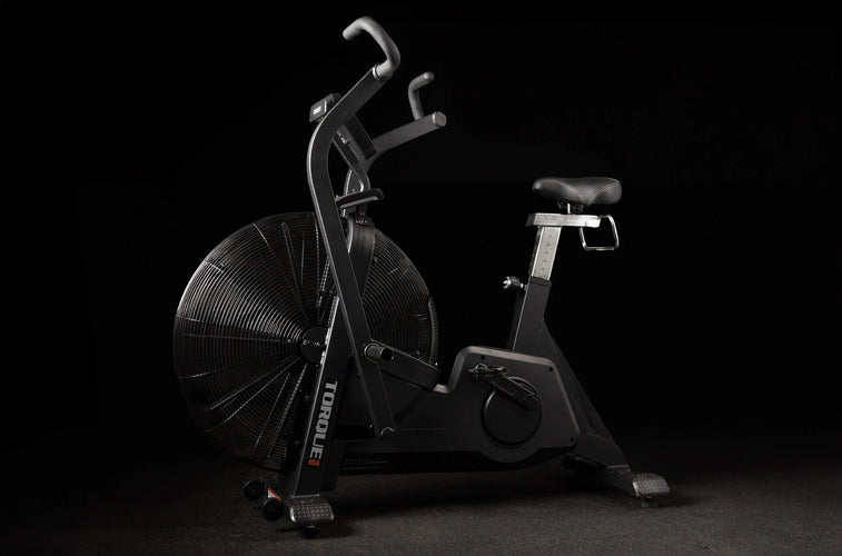 Torque Fitness Stealth Air Bike, fan-resistance air bike with console and moving handles product view.