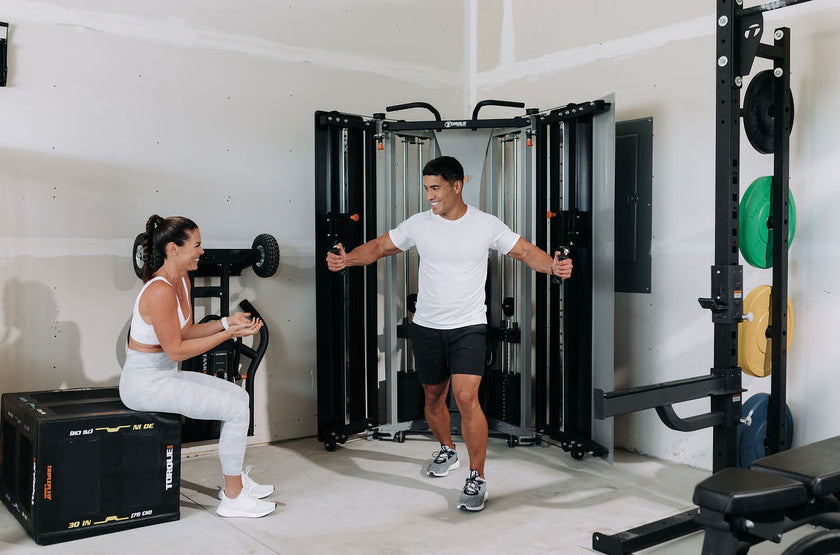 Woman Sitting On Torque Plyo Box In Garage Gym