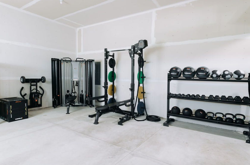 Garage Gym Outfitted With Torque Equipment and Colored Bumper Plates