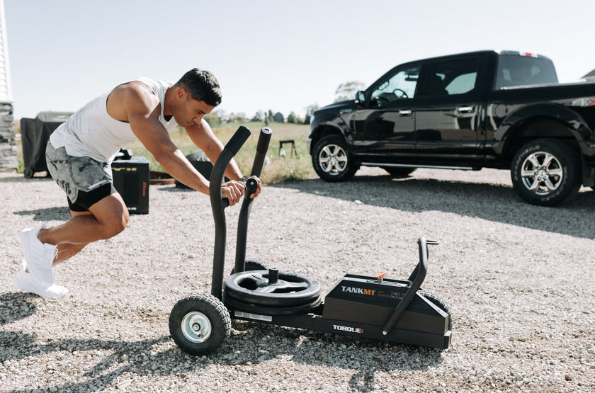 Man Pushing TANK M1 Loaded With Grip Plates