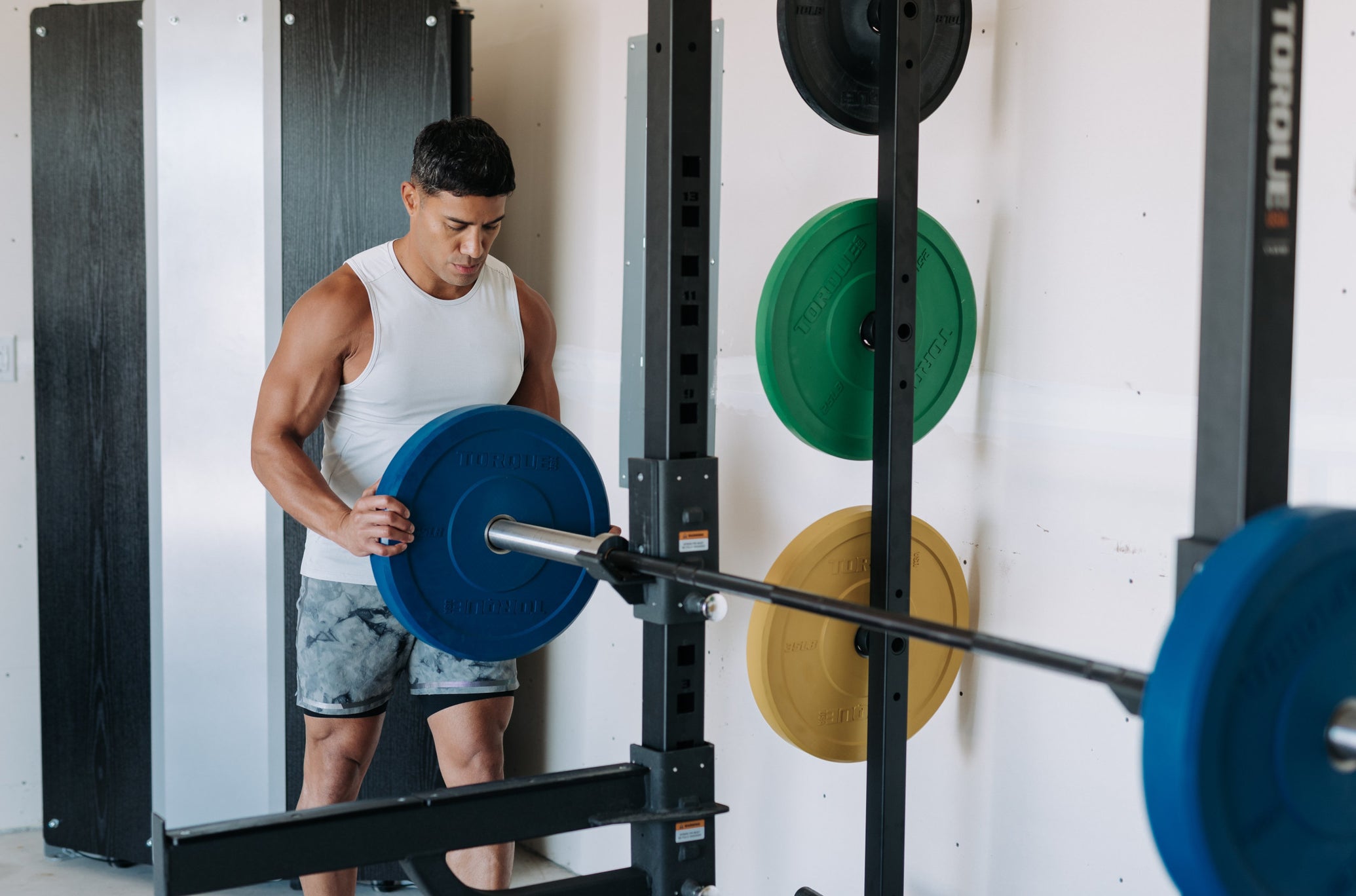 Man Using Torque Colored Bumper Plates